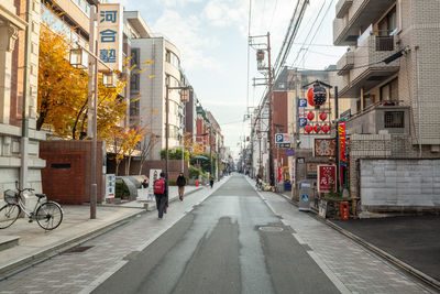 Street amidst buildings against sky