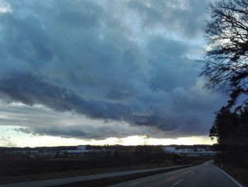 Road by city against sky