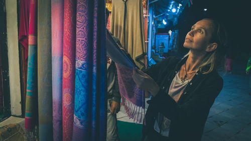 Woman buying scarf at market