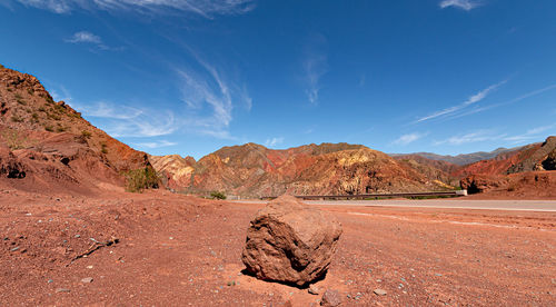 Scenic view of desert against blue sky