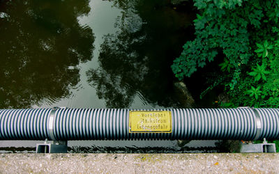Information sign on field by trees in park