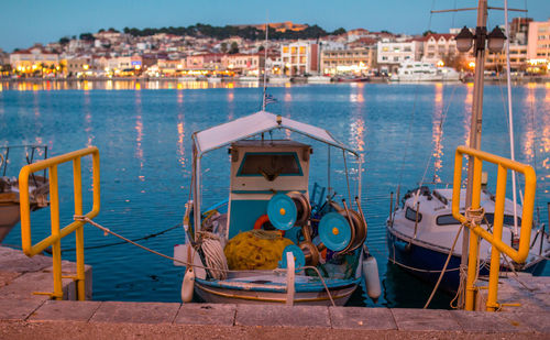 Boats moored in sea against sky