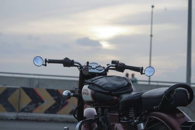 Close-up of bicycle on road against sky