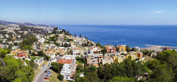 High angle view of townscape by sea against sky