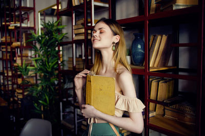 Young woman looking at book