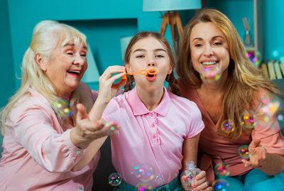 Happy family playing with bubbles at home