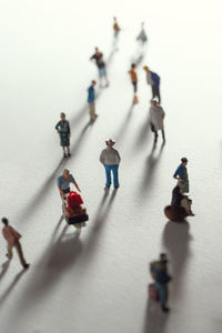 High angle view of people with toy walking on white background