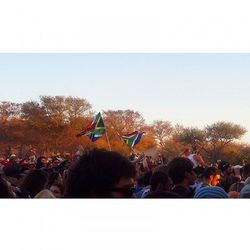 Crowd enjoying music concert against sky