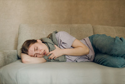 Young woman lying on bed at home