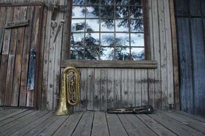Trumpet outside wooden hut