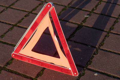 High angle view of road sign on footpath