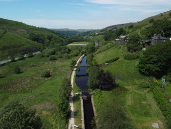 High angle view of green landscape against sky