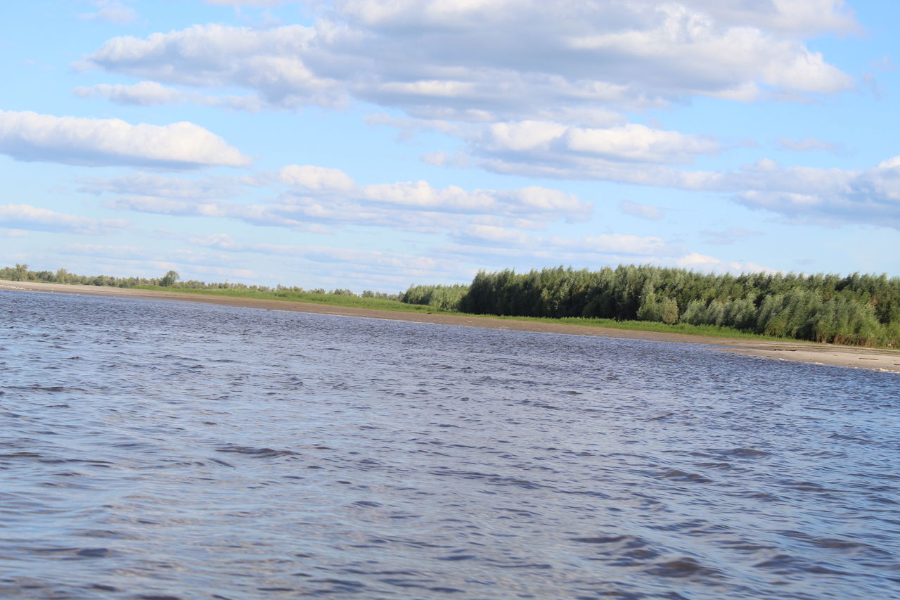 water, sky, cloud, shore, scenics - nature, lake, reservoir, nature, beauty in nature, plant, environment, tree, no people, day, land, tranquility, tranquil scene, landscape, non-urban scene, outdoors, body of water, vehicle, travel, blue, travel destinations, boating, wetland, marsh