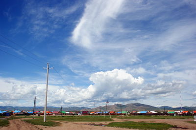 Electricity pylon on land against sky