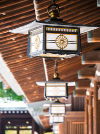 Low angle view of clock hanging on ceiling in building