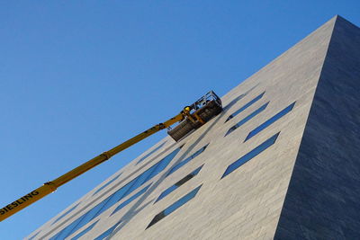 Low angle view of building against clear blue sky