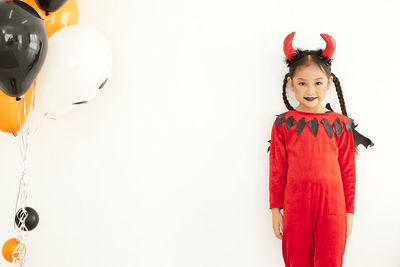 Portrait of girl standing against white background