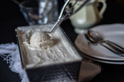 Close-up of ice cream in container on table