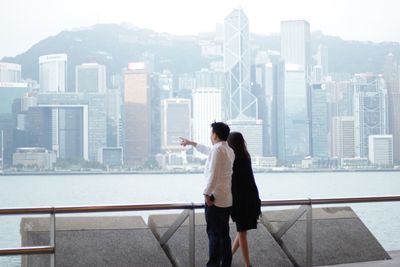 Rear view of man looking at city buildings