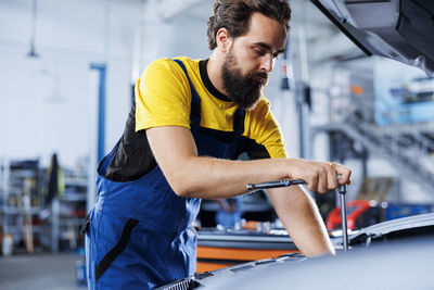 Side view of man working in factory