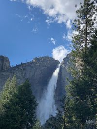 Low angle view of waterfall against sky