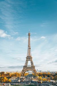 Eiffel tower in city against sky