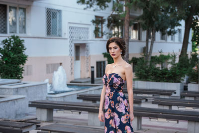 Portrait of young woman standing outdoors