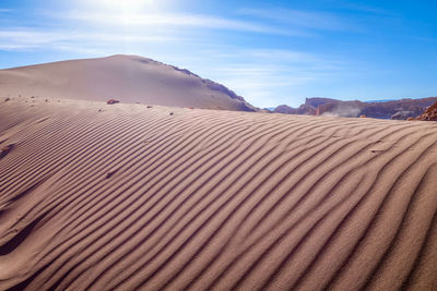 Sand dune in desert against sky