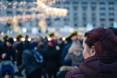 Woman looking away at festival in city