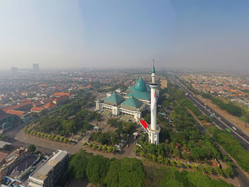 High angle view of road by buildings against sky