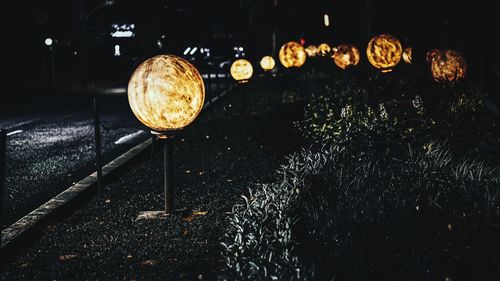 Close-up of illuminated lighting equipment at night