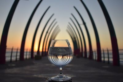 Light bulb on beach against sky during sunset