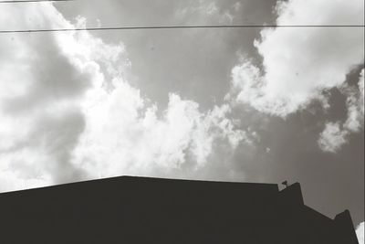 Low angle view of building against cloudy sky
