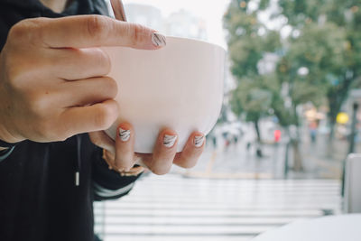 Close-up of woman holding food in bowl