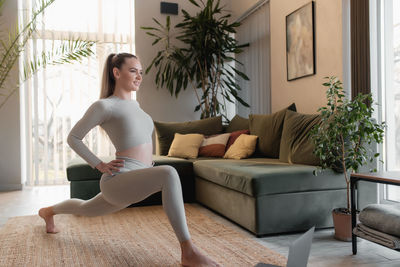 Woman sitting on sofa at home