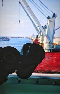 Close-up of boat against sky seen through window