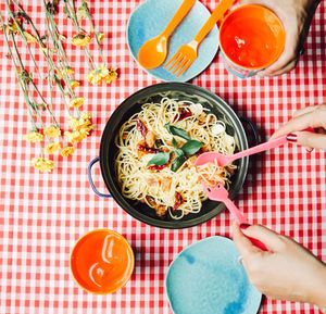 Cropped image of woman hands serving noodles