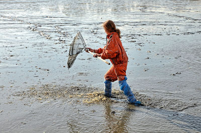 Woman fishing in sea