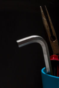 Close-up of machine on table against black background