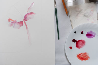 High angle view of pink rose on table