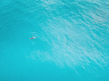 High angle view of man paddleboarding in sea