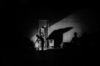 Men working on equipment in dark room