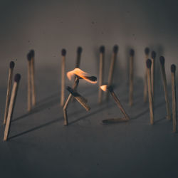 Close-up of matchsticks against gray background