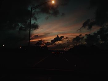 Silhouette trees against sky at night