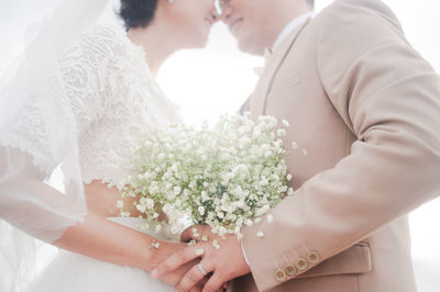 Bride and bridegroom holding bouquet
