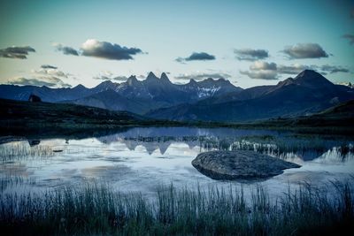 Scenic view of lake and mountains against sky