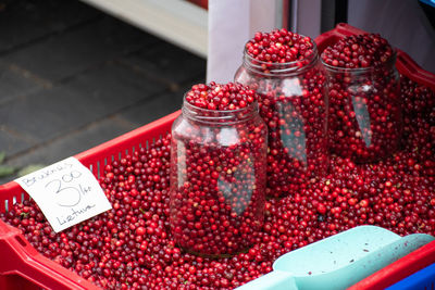 Red fresh healthy cranberries and lingonberries in a street food market ready to sell and eat