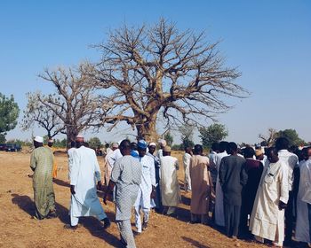 Group of people against clear sky