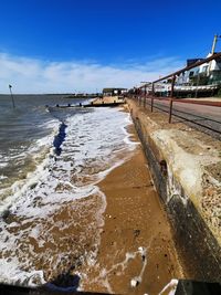 Scenic view of beach against blue sky