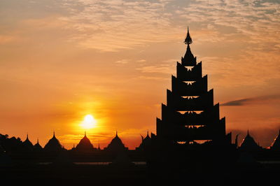 Silhouette temple against sky during sunset